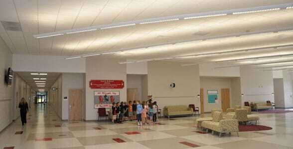 Commercial Epoxy Floor Coating This image shows the inside of a school with kids standing near the door.
