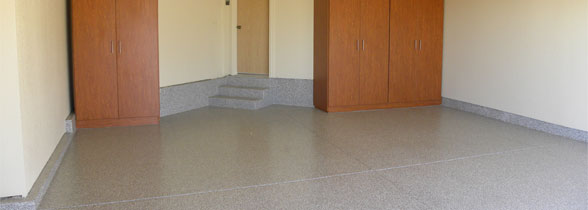 The image shows an empty garage floor flake epoxy flooring on it.
