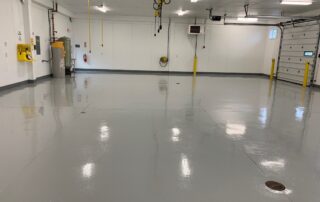 This image shows a garage with grey epoxy floor.